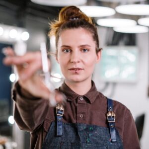 Man in Black and Blue Button Up Shirt Holding White Disposable Cup